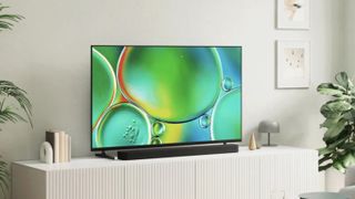 The Bravia 2 II QLED TV displaying a colorful picture of bubbles on a credenza in a modern living room
