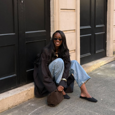  @_livmadeline wears jeans and black satin mules