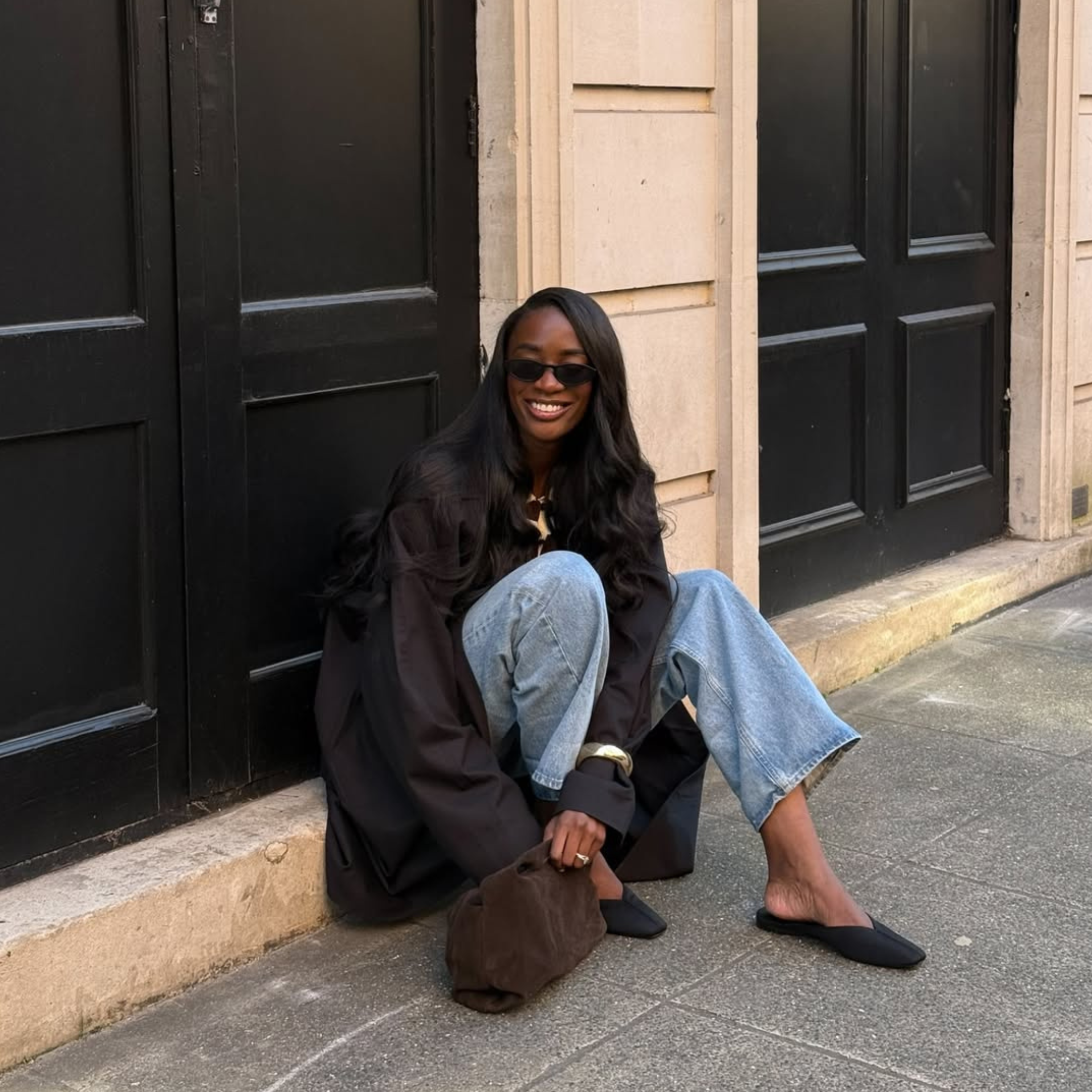  @_livmadeline wears jeans and black satin mules