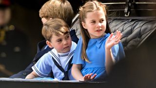 Princess Charlotte and Prince Louis ride in a carriage during Trooping the Colour