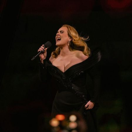 Adele wearing a custom black dress while performing onstage at Weekends with Adele 
