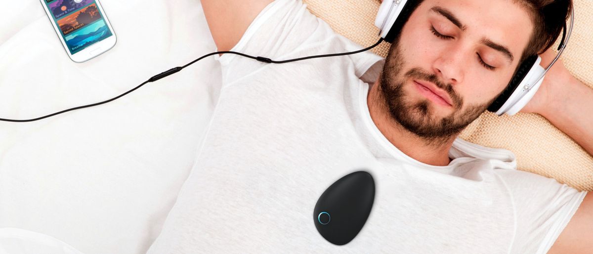 Man with Sensate 2 on chest, listening to sounds from Sensate app