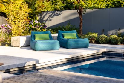 A backyard patio with blue outdoor seating