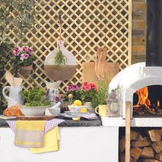 Garden with pizza oven and cooking station made from trellis