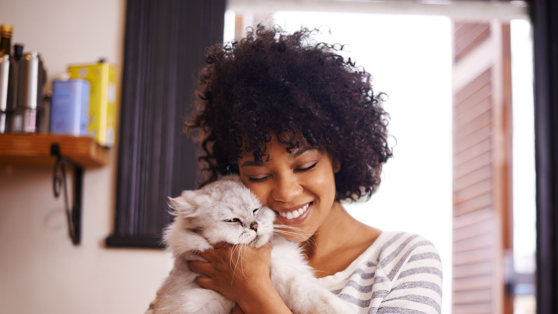 woman snuggling cat