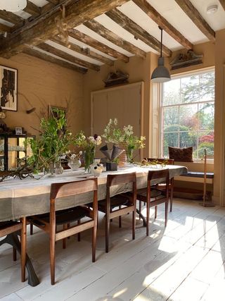 A dining room painted in a soft neutral shade