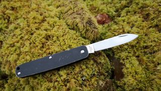 Fällkniven LTC camping knife unfolded on mossy log