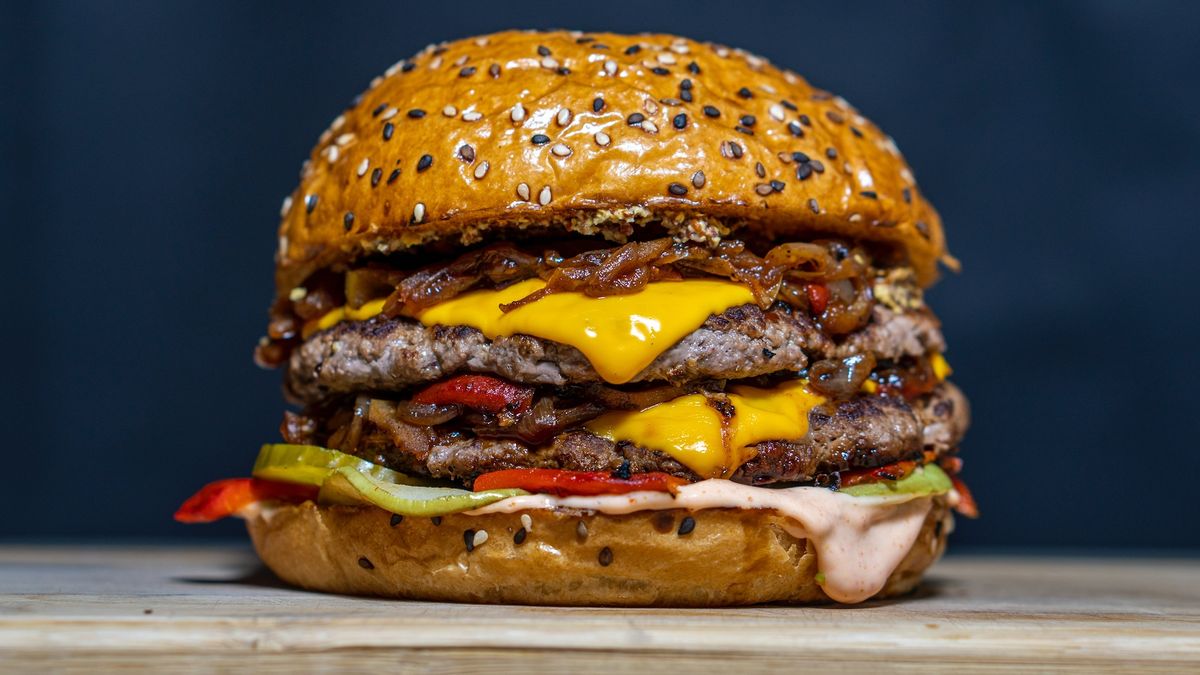 a close-up of a large cheeseburger