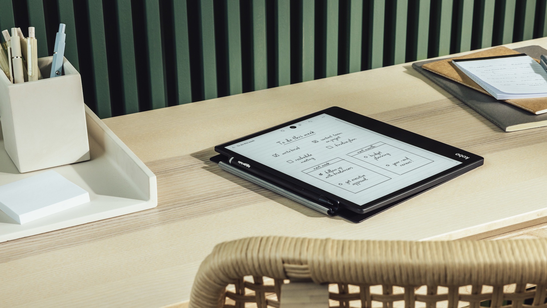 The Kobo Elipsa 2E on a desk in its sleepcase with Stylus 2.