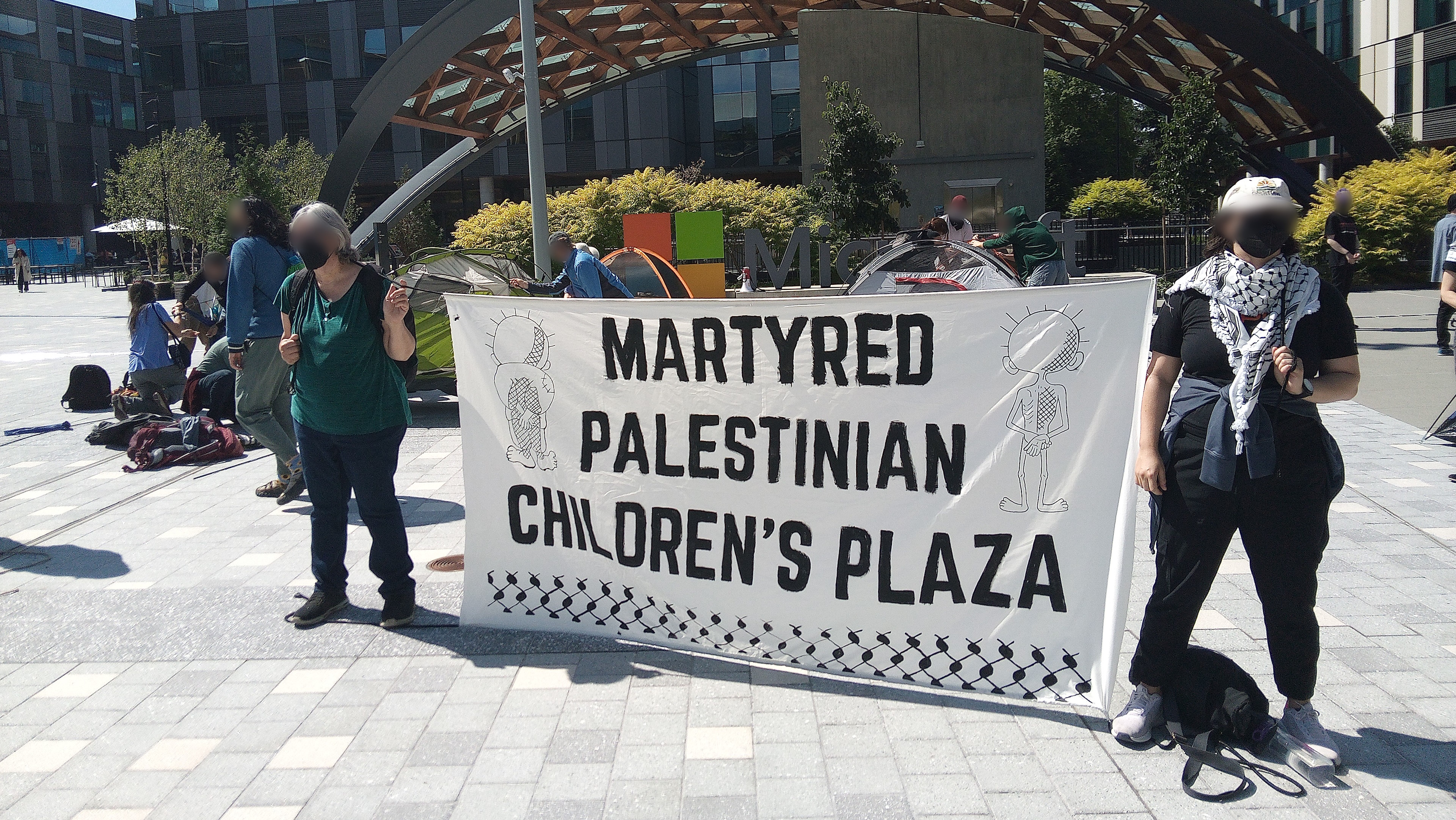 No Azure for Apartheid protesters holding Martyred Palestinian Children&#039;s Plaza sign