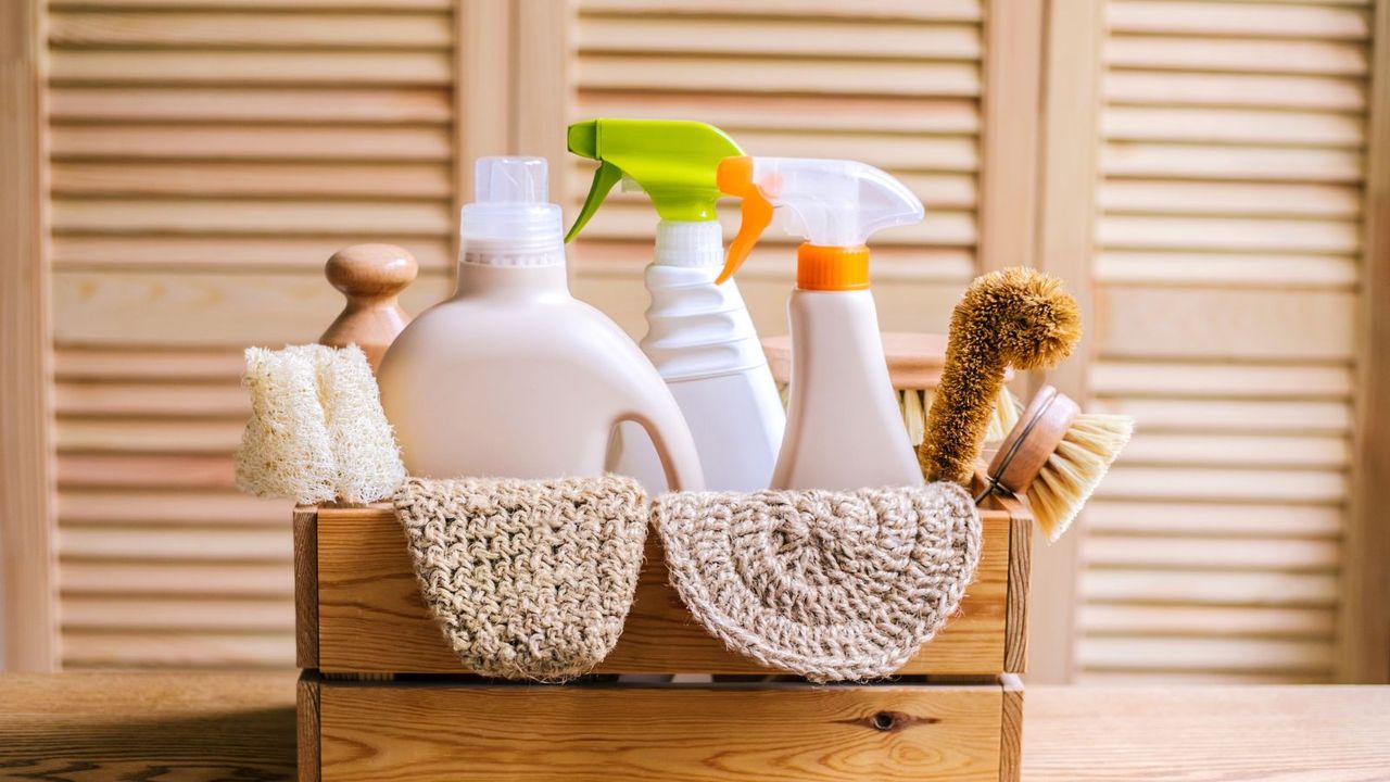 A wooden crate of cleaning tools