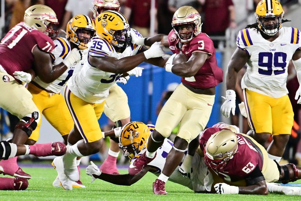 Trey Benson #3 of the Florida State Seminoles breaks a tackle from Sai&#039;vion Jones #35 of the LSU Tigers in the first quarter at Camping World Stadium on September 03, 2023 in Orlando, Florida. 