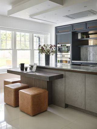 Kitchen with island and bar table and floor to ceiling cabinets