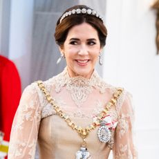 Queen Mary of Denmark attends the New Year's Day Parade hosted by her husband King Frederik X of Denmark in Copenhagen, Denmark wearing a lace and silk golden gown and a tiara on January 1, 2026 