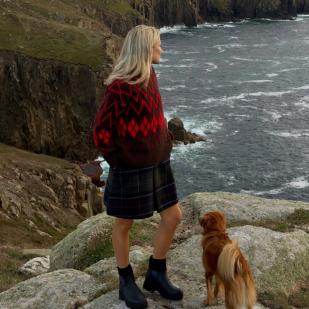 Influencer Lucy Williams wearing an argyl jumper, tartan shorts and ankle boots. 