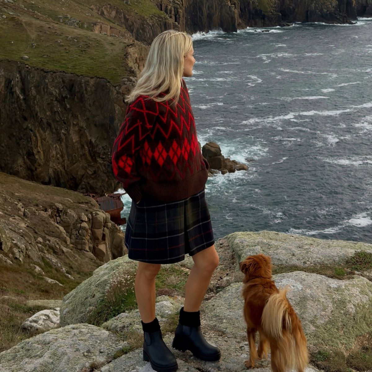 Influencer Lucy Williams wearing an argyl jumper, tartan shorts and ankle boots. 