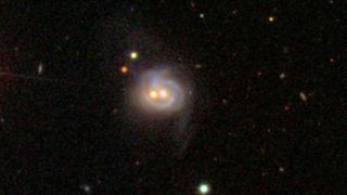 Viewed in visible light, Markarian 739 resembles a smiling face. It actually is a pair of merging galaxies which lies 425 million light-years away. 