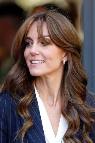 Kate Middleton pictured with curtain bangs and curls during a visit to the Grange Pavilion in October 2023