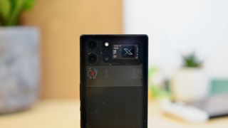 The Nubia Red Magic 10 Pro phone sitting on a wooden table