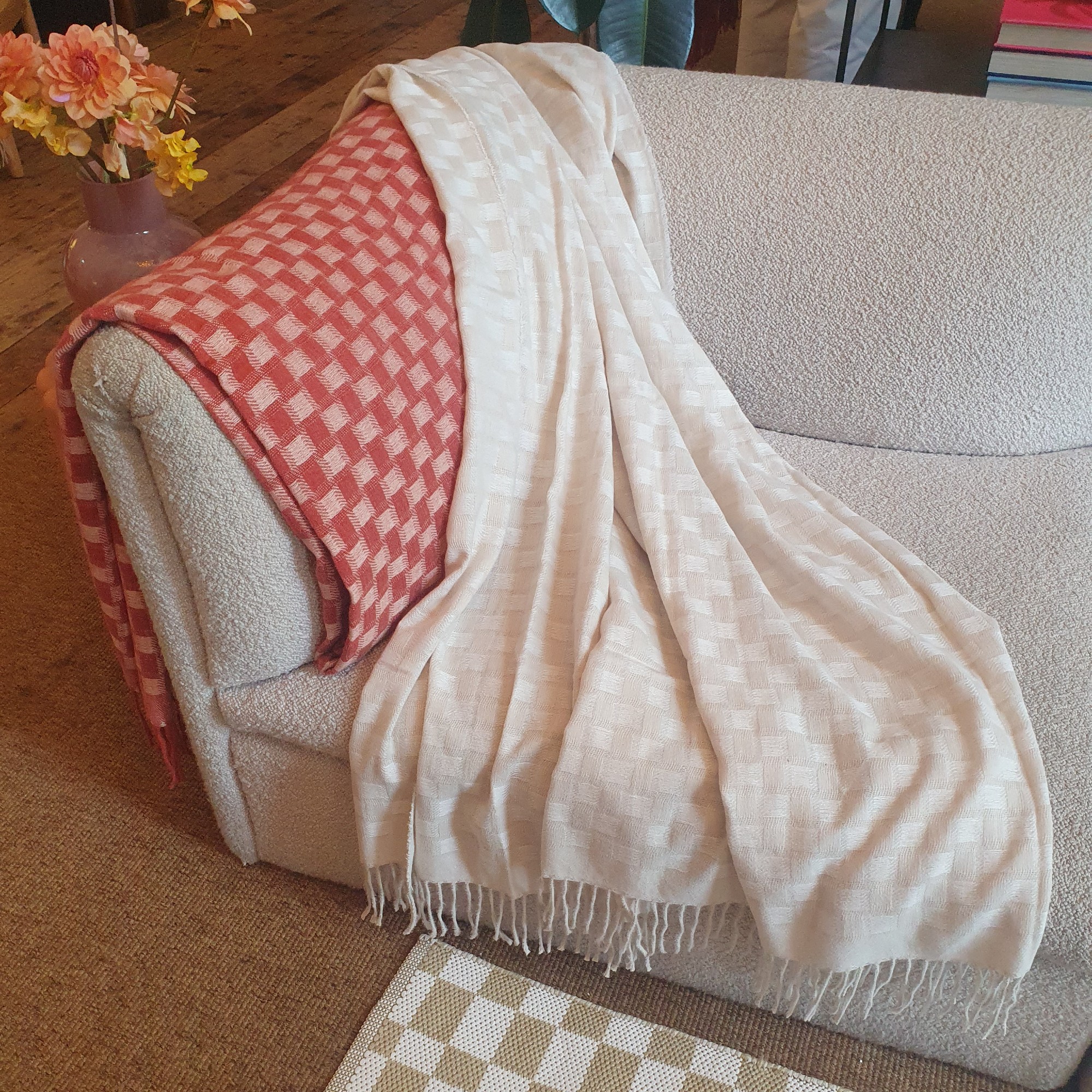 Checkered throws from the Bundleberry by Amanda Holden for QVC range at the press preview, draped over a boucle sofa