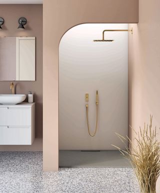 Bathroom trends example showing a pink built in shower and grey marble floor.