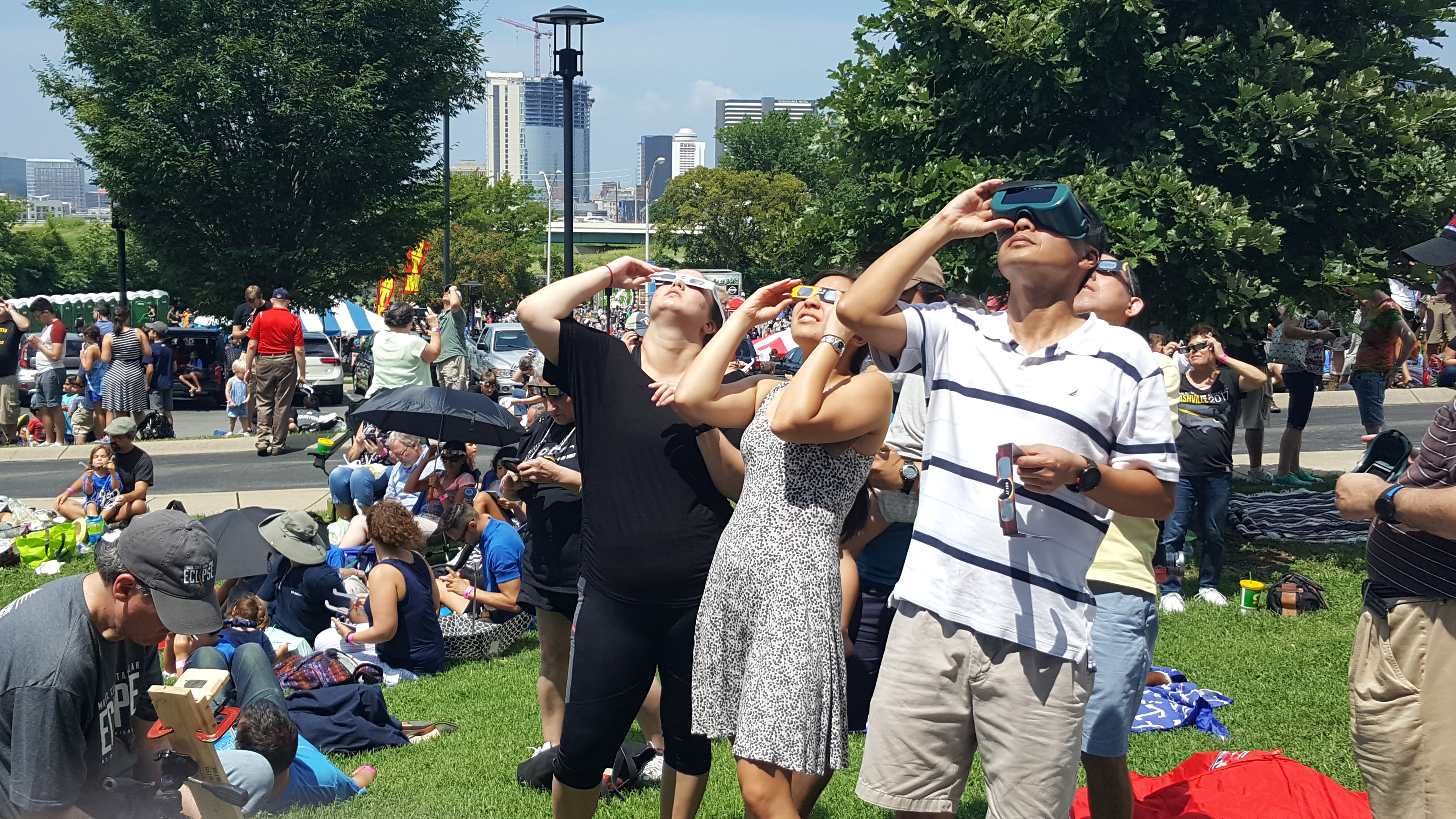 Skywatchers use eclipse glasses to safely observe the total solar eclipse of Aug. 21, 2017, in Nashville, Tennessee.