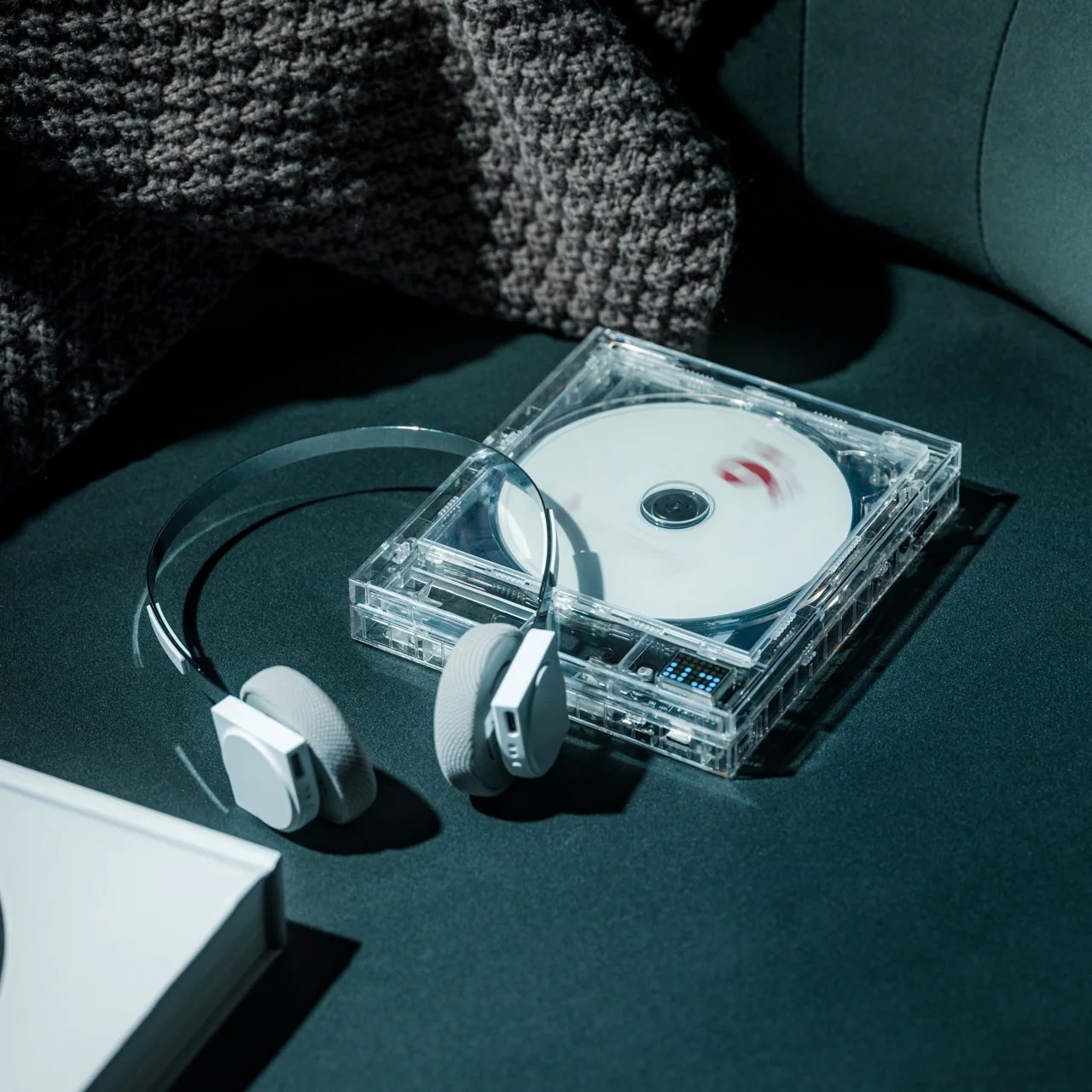 YD Select's Clearframe CD player on a car seat with headphones sat on top