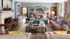 traditional powder blue living room with eclectic english style, a fireplace, upholstered ottoman and mis matched patterned sofas and armchairs