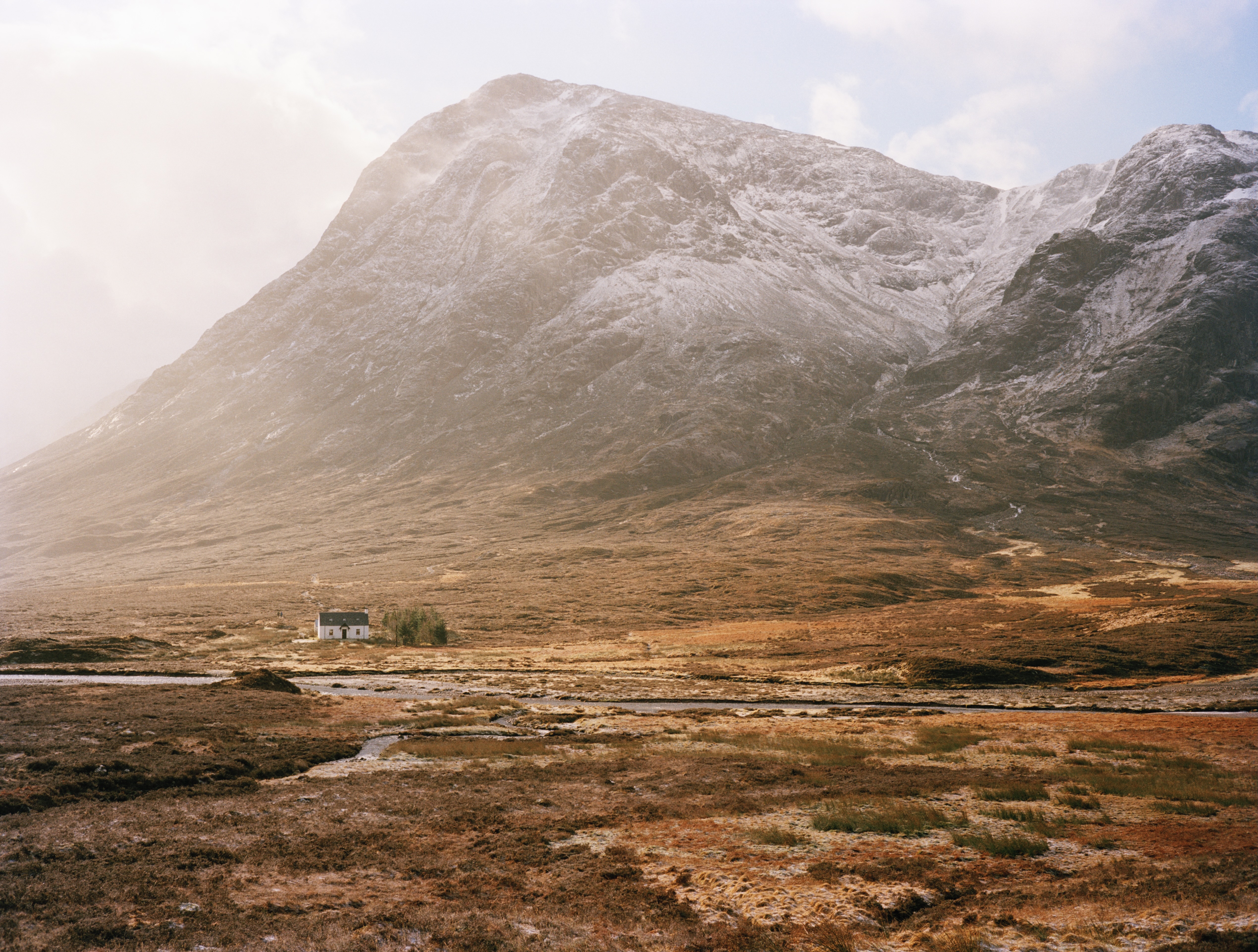 Farmhouse at the foot of mountain range