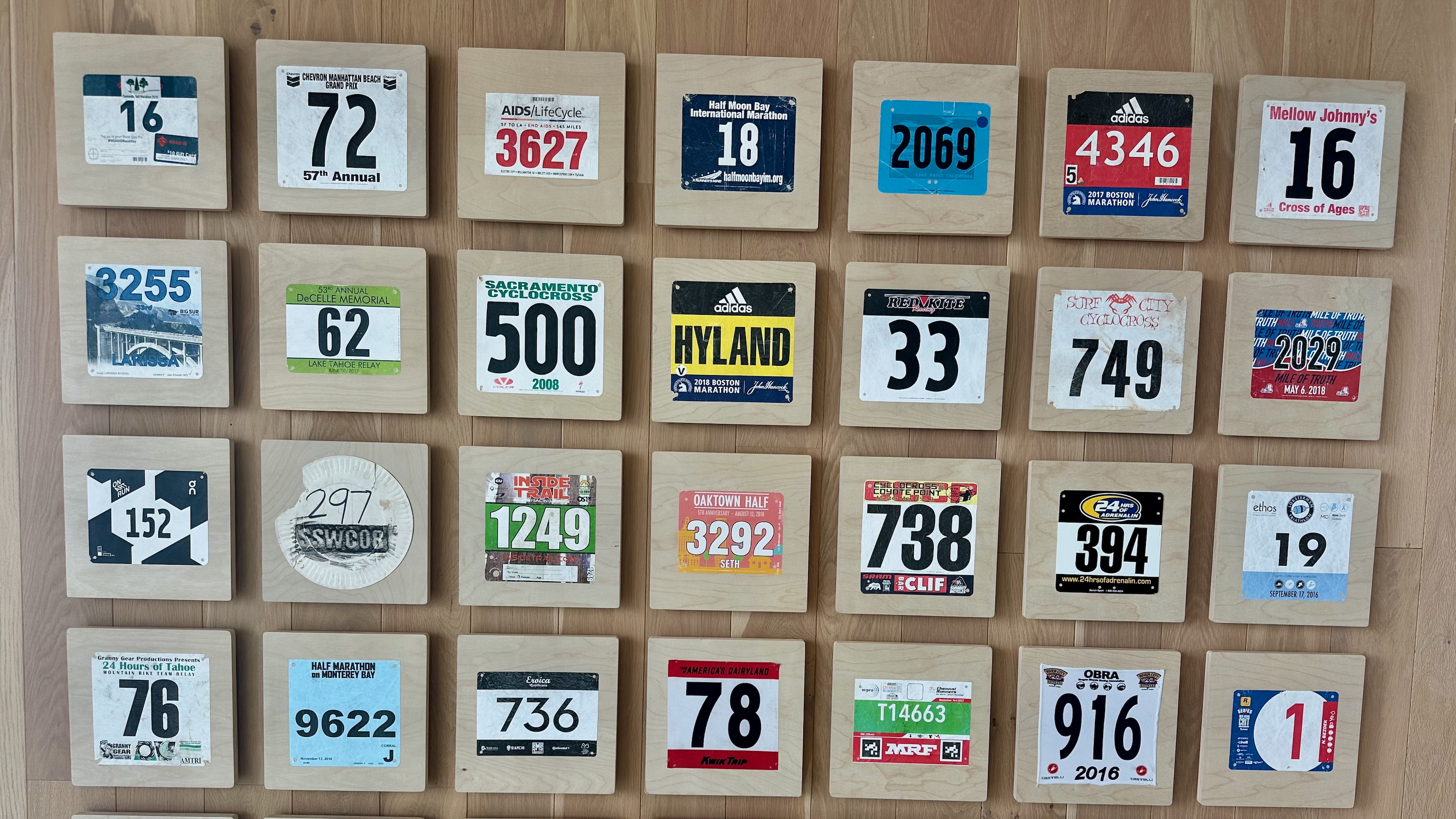 A wall of Strava employees' race bibs at their new office in San Francisco