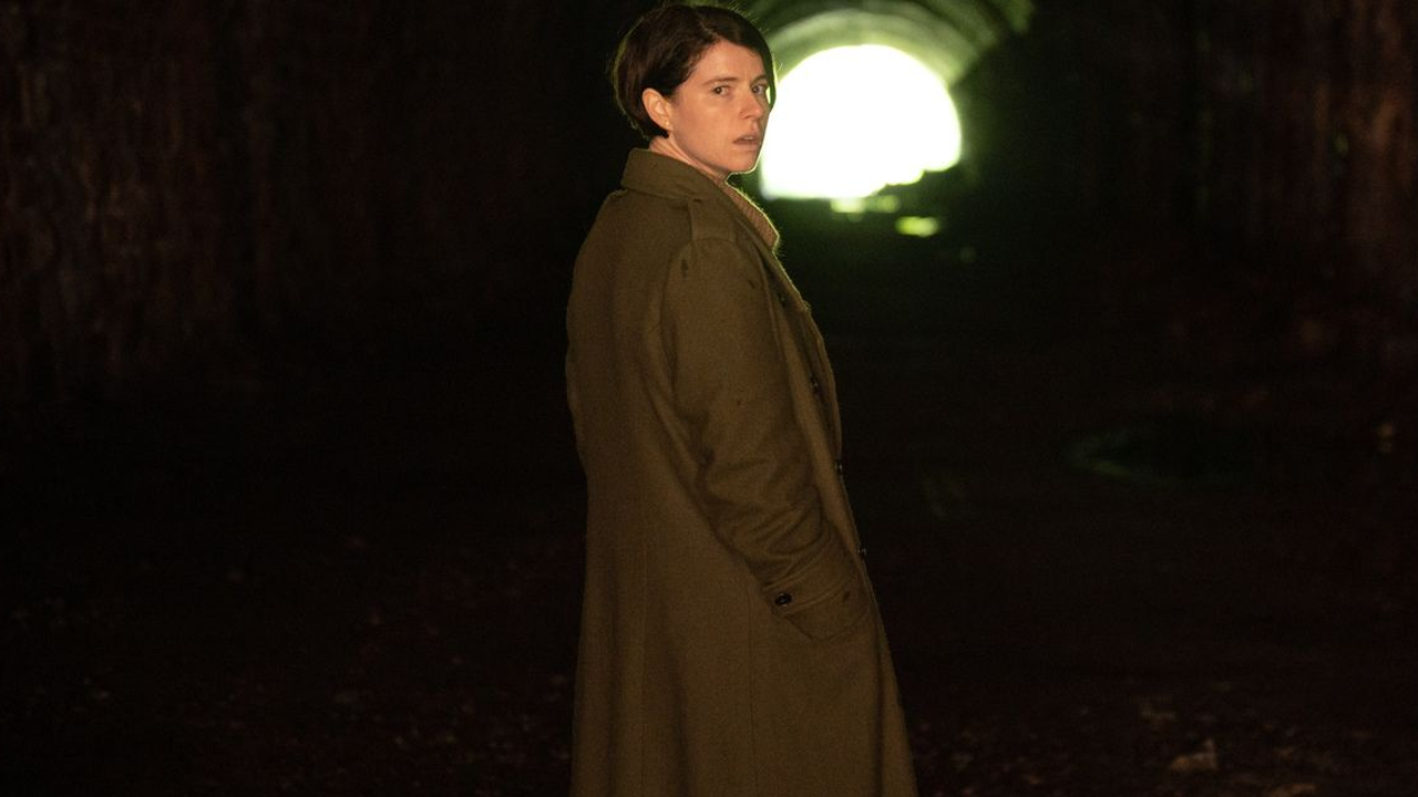 Jessie Buckley looking back in a foreboding tunnel in Men.