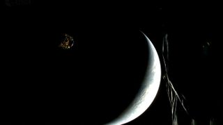 a spacecraft is seen beside a crescent earth