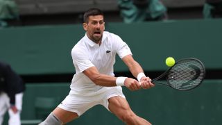 Novak Djokovic of Serbia plays a backhand on his way to the Alcaraz vs Djokovic Wimbledon Men's final 2024.