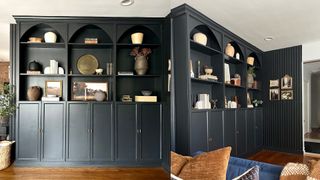 Dark built-in shelves with storage in living room