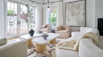 minimalist living room with light furniture, curved sofa