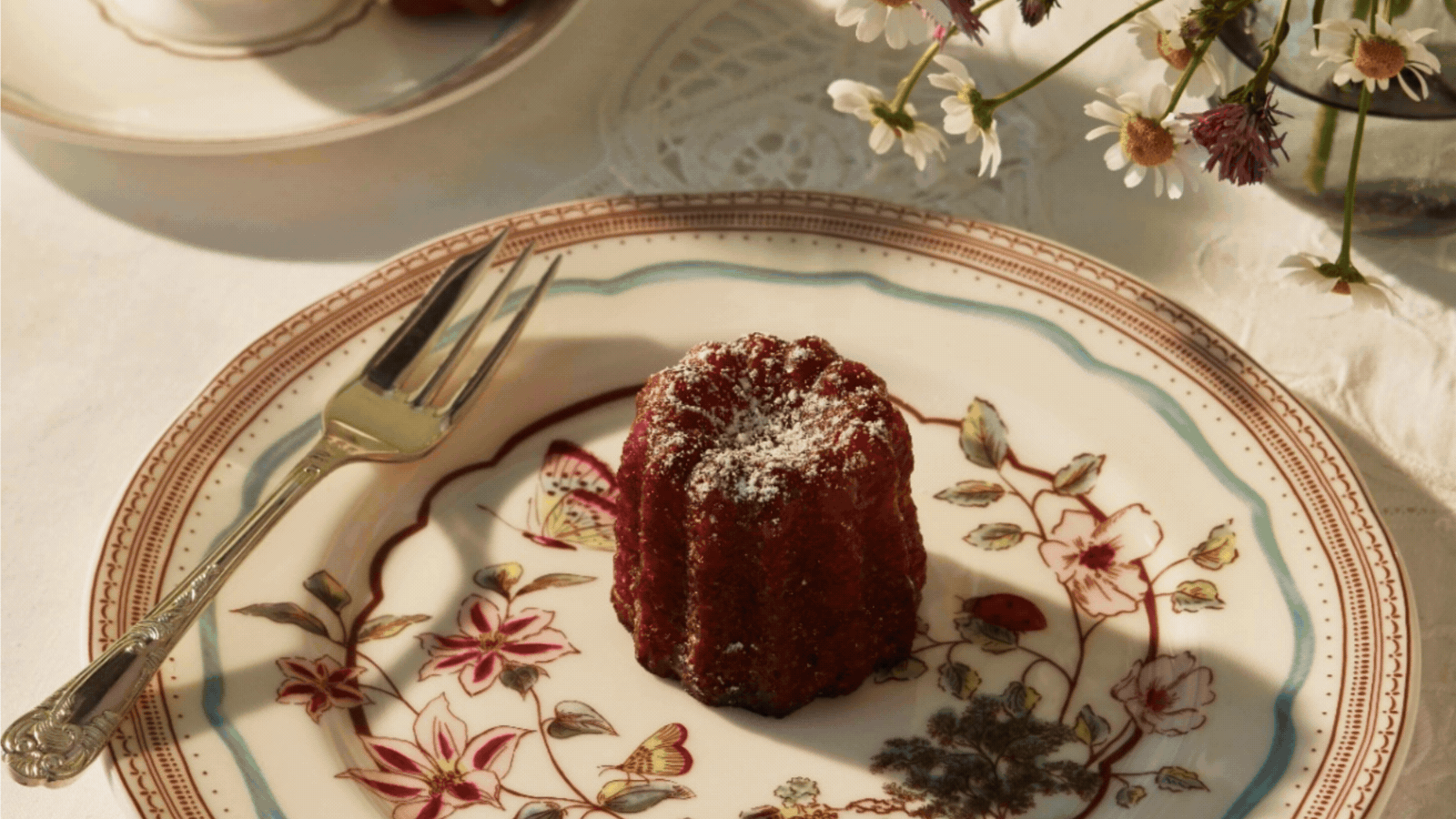 Rotating GIF of three images of floral dinner plates on a table setting. The images are close ups with food on the plates.