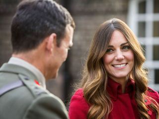Kate Middleton wears a long red coat at the Poppy Day Parade in London