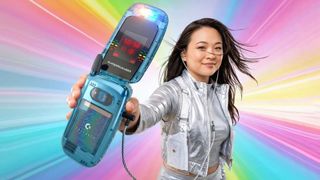 A woman in a shiny top and backpack holster holds a Commodore Callback flip phone