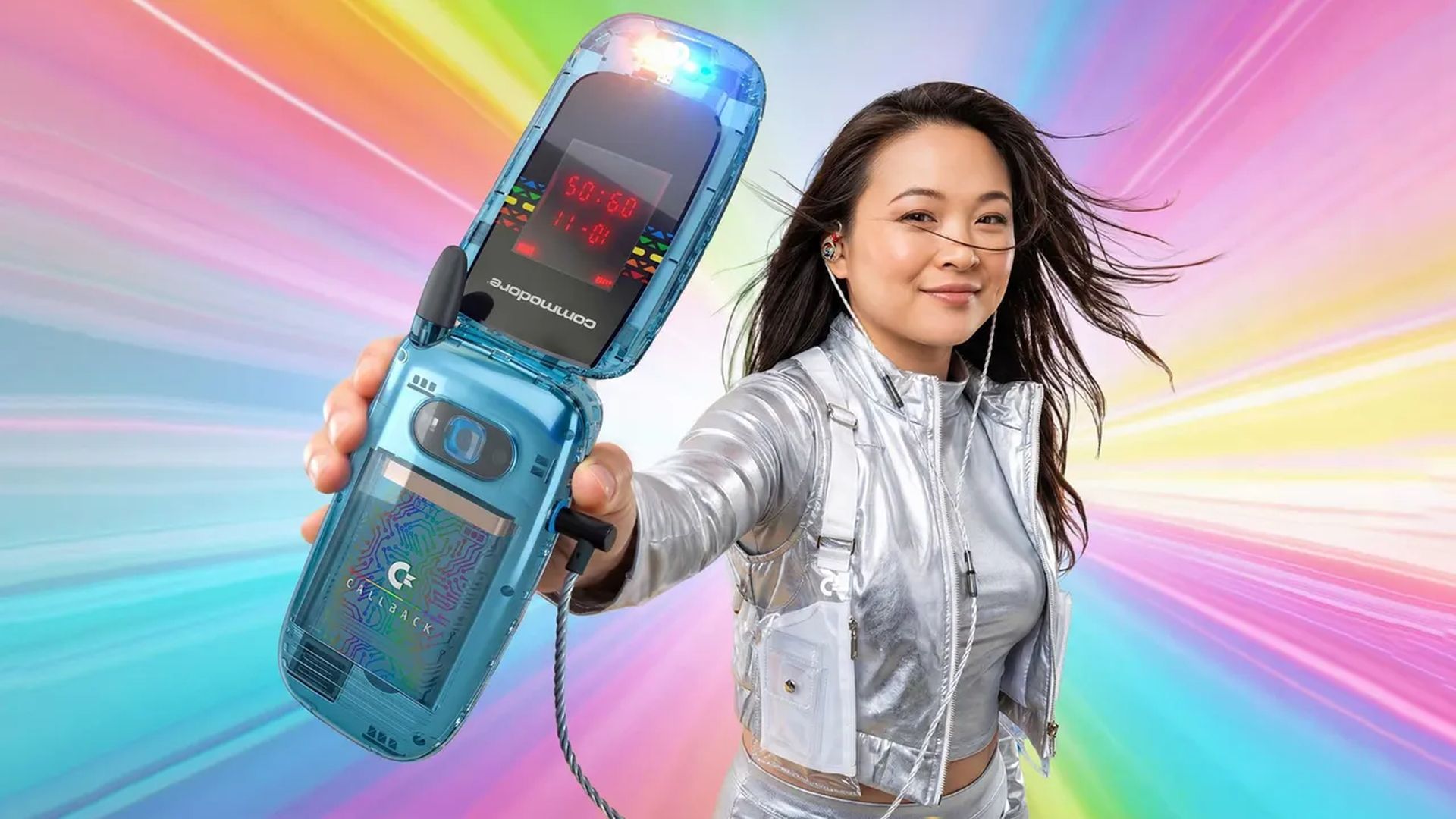 A woman in a shiny top and backpack holster holds a Commodore Callback flip phone