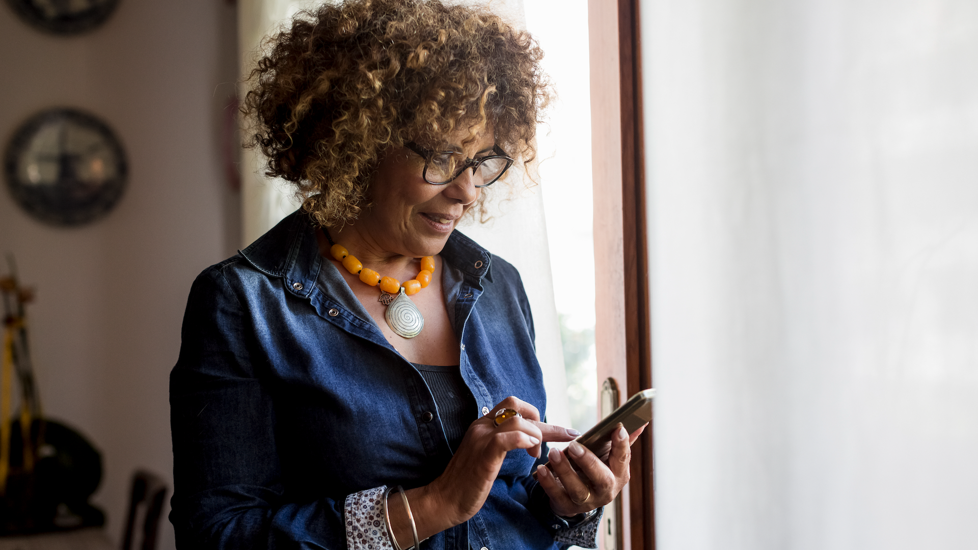 Woman looking at phone indoors