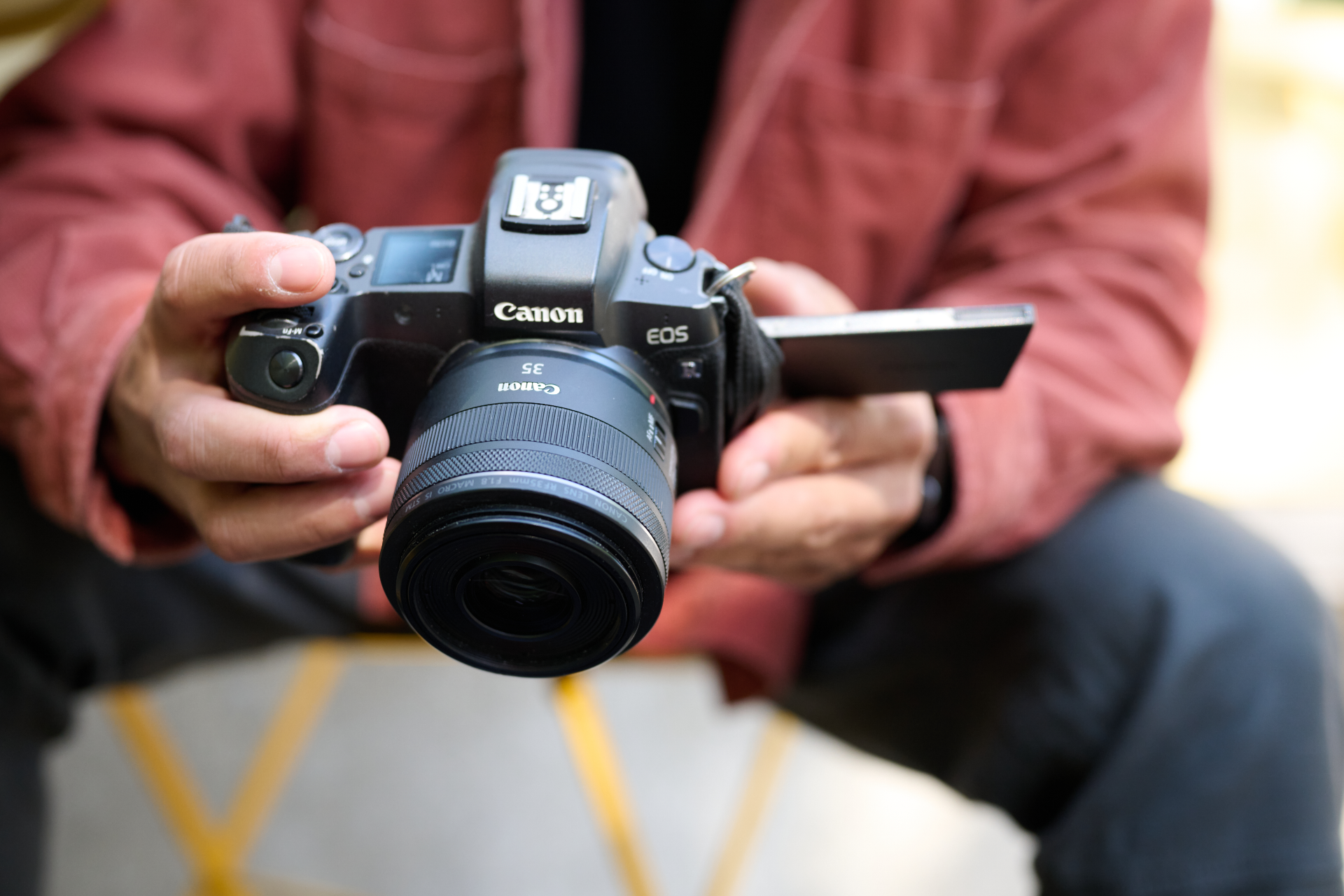 Man holding Canon DSLR
