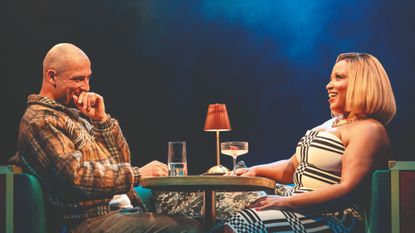 Jamael Westman and Marisha Wallace sitting opposite each other drinking cocktails