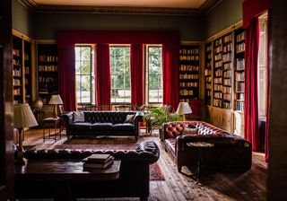 library with wooden flooring and sofa