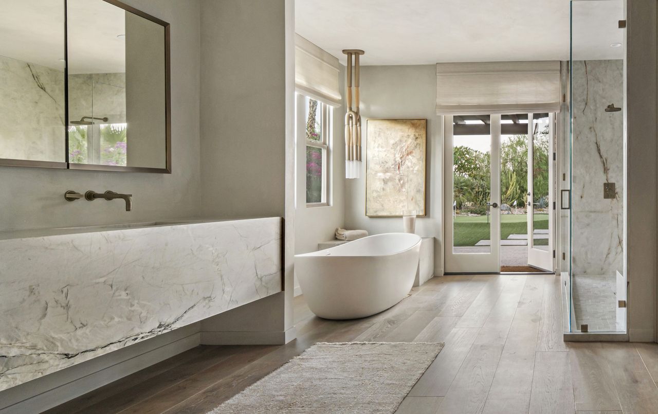 A bathroom with tactile walls and a large bathtub 