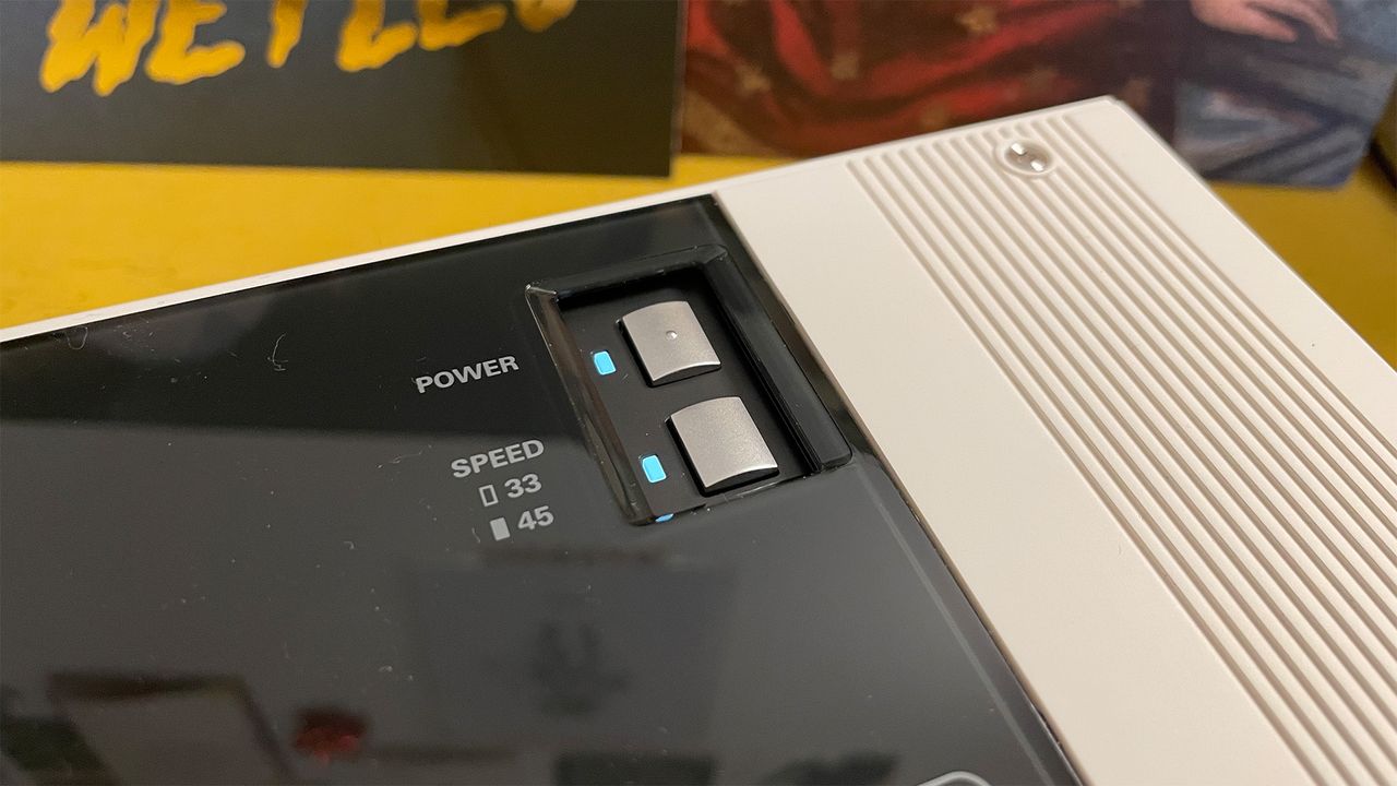A close-up of the controls on a white Audio-Technica Sound Burger turntable