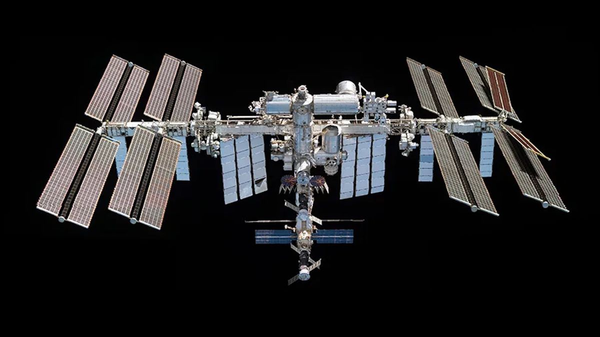 view of the international space station through the window of a departing spacecraft