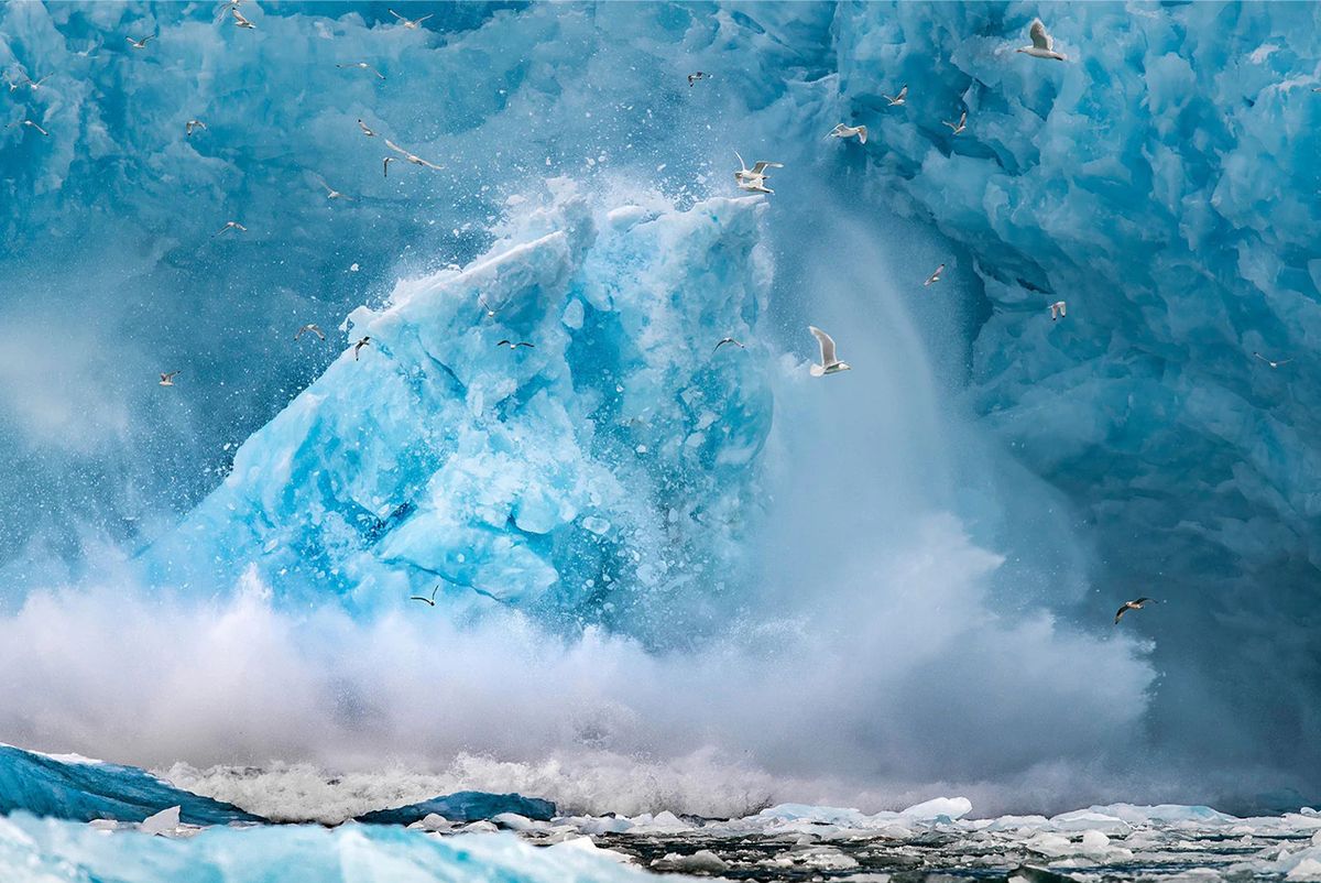 Colour photograph of an iceberg floating in the Arctic Ocean, in Svalbard, a Norwegian archipelago