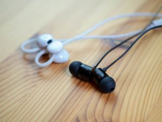 Google Pixel Buds next to OnePlus Bullets