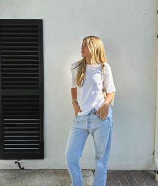 Sofia Richie Grainge wearing a white T-shirt, yellow Bottega Veneta Andiamo bag, and vintage 501 Levi's jeans.