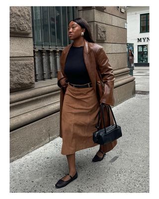 Nnenna Chem wears a suede midi skirt